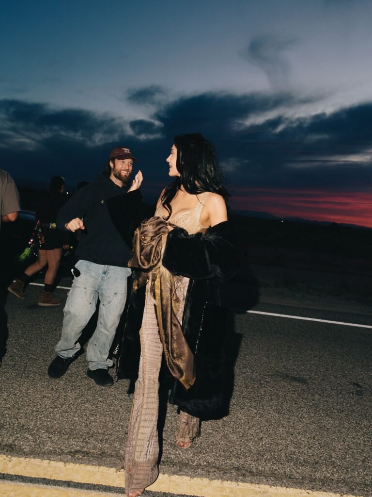 Behind-the-scenes of Kylie Jenner music video shoot at sunset with film crew on desert highway