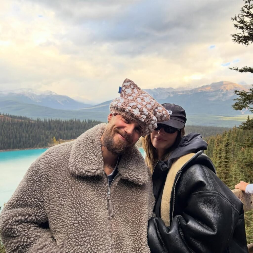 Justin and Hailey Bieber kiss during romantic mountain getaway with turquoise lake and snow-capped peaks in background
