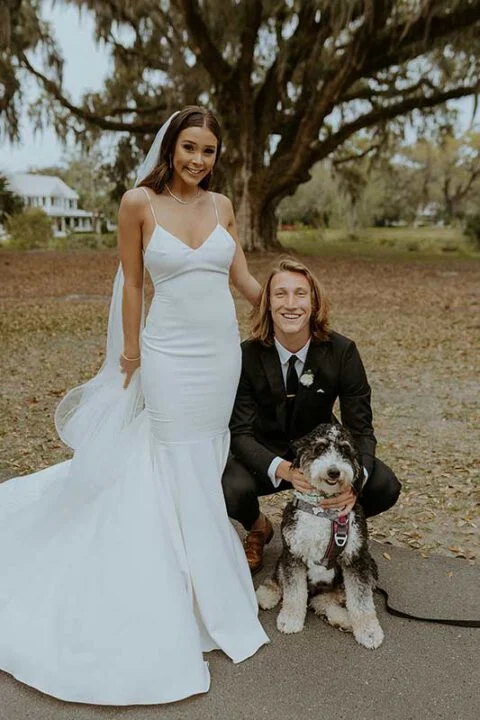 Trevor and Marissa Lawrence wedding portrait with their dog, bride in fitted mermaid gown and groom in black suit