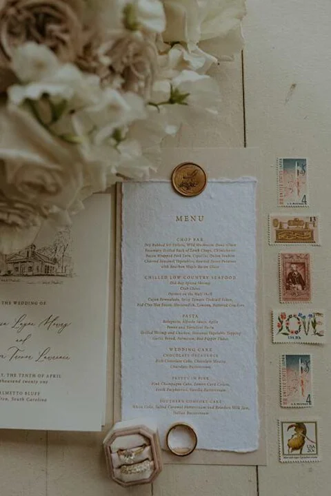 Wedding invitation suite with menu card, rings, wax seal, vintage stamps and white flowers for Trevor and Marissa Lawrence