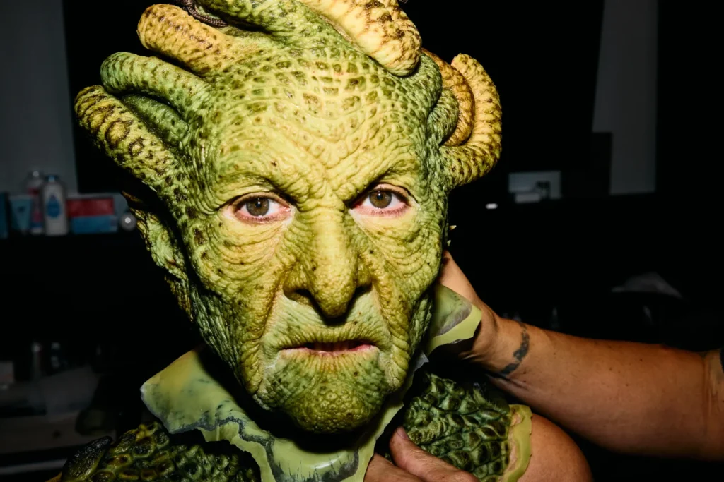 Close-up of Heidi Klum's detailed Medusa prosthetic face showing textured scales and reptilian features
