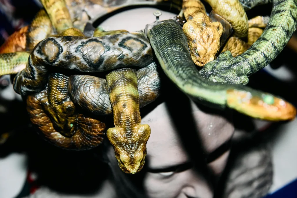 Detailed view of mechanical snake components with hand painted scales and articulated design for Medusa costume