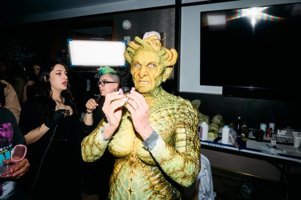 Heidi Klum in nearly complete Medusa costume with full body scales backstage before event