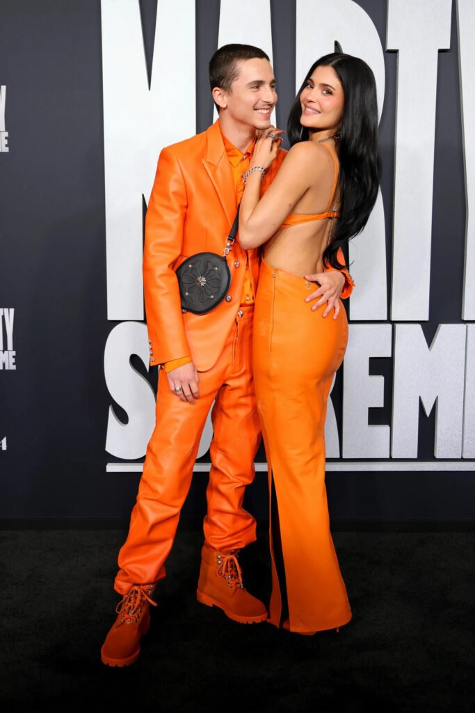Chalamet and Jenner embrace on red carpet in coordinated orange ensembles