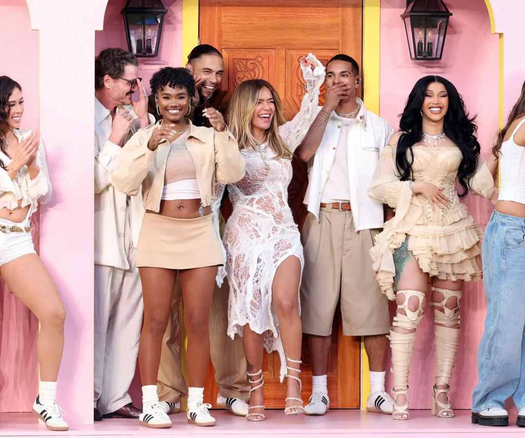Celebrity guests including Karol G and Cardi B celebrate together on a colorful stage during Bad Bunny’s Super Bowl halftime show