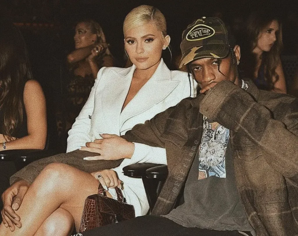 Travis Scott and Kylie Jenner seated together at a fashion event