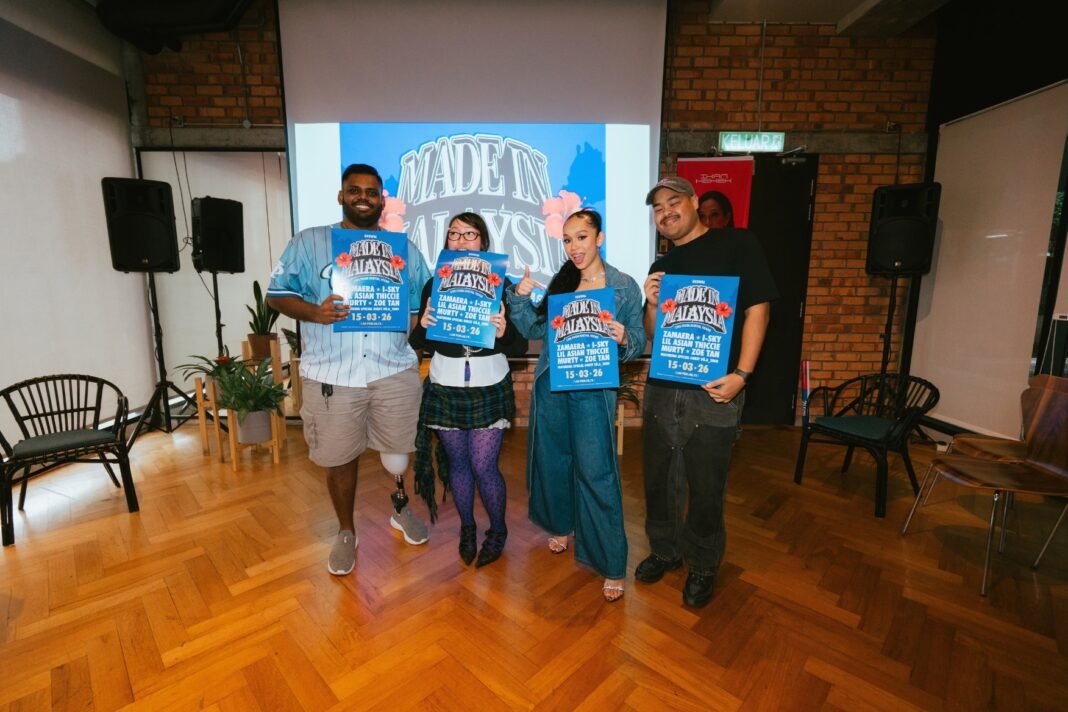 Four people standing indoors holding Made in Malaysia SXSW showcase posters during a promotional event.
