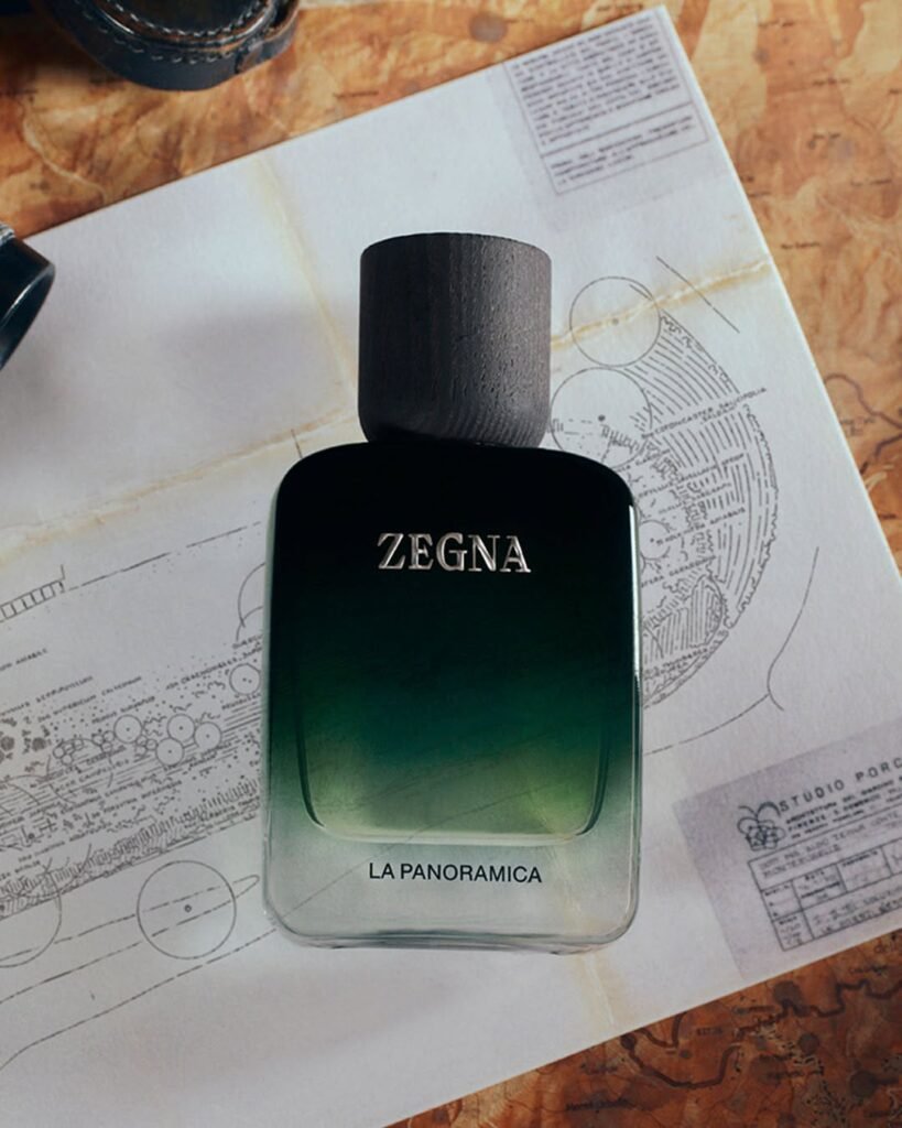 ZEGNA-MEMORIE-La-Panoramica-fragrance-bottle-in-deep-forest-green-gradient-resting-on-vintage-botanical-and-architectural-blueprints-on-a-worn-map-surface