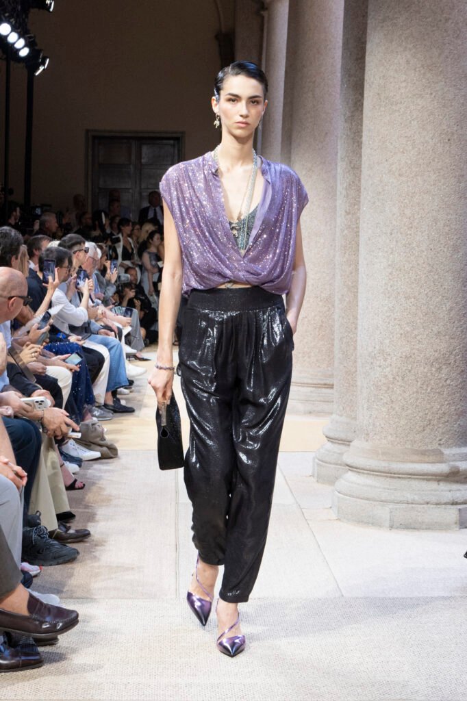 A-model-walks-the-Giorgio-Armani-Cruise-2027-runway-in-a-draped-lilac-sequin-top-and-shimmering-black-trousers