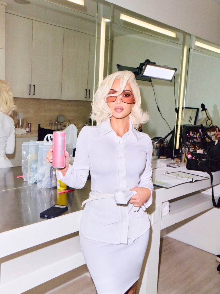 Kim-Kardashian-in-a-platinum-wig-holds-a-pink-Update-energy-drink-can-backstage-at-the-shoot-scaled