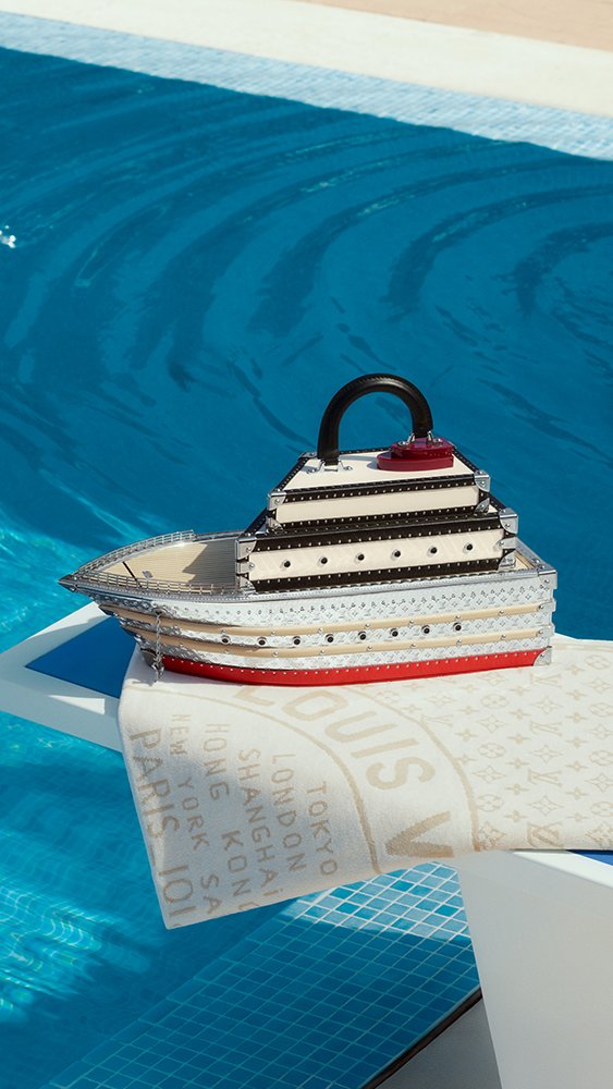 Louis-Vuitton-Louis-Boat-Trunk-a-ship-shaped-Monogram-collectors-case-displayed-poolside-on-a-towel
