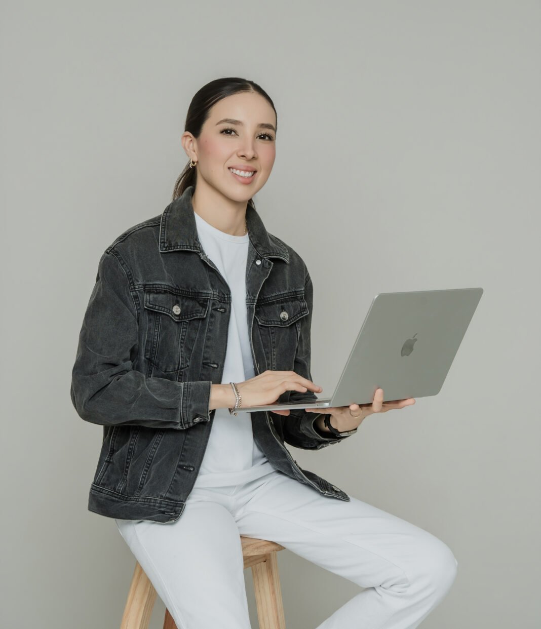 Mariana Maldonado, CMO and CTO of BlueFunnel AI & Co, smiling with arms crossed, wearing a navy BlueFunnel AI & Co branded polo shirt