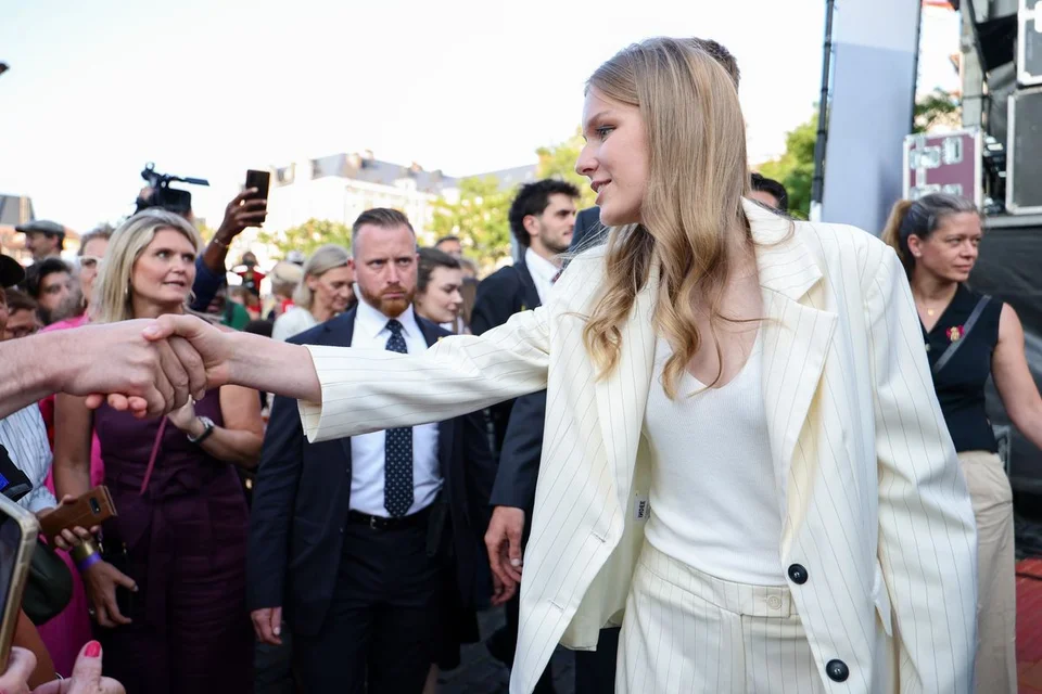 Princess-Eleonore-of-Belgium-in-a-cream-pinstripe-suit-greeting-crowds-at-a-National-Day-event