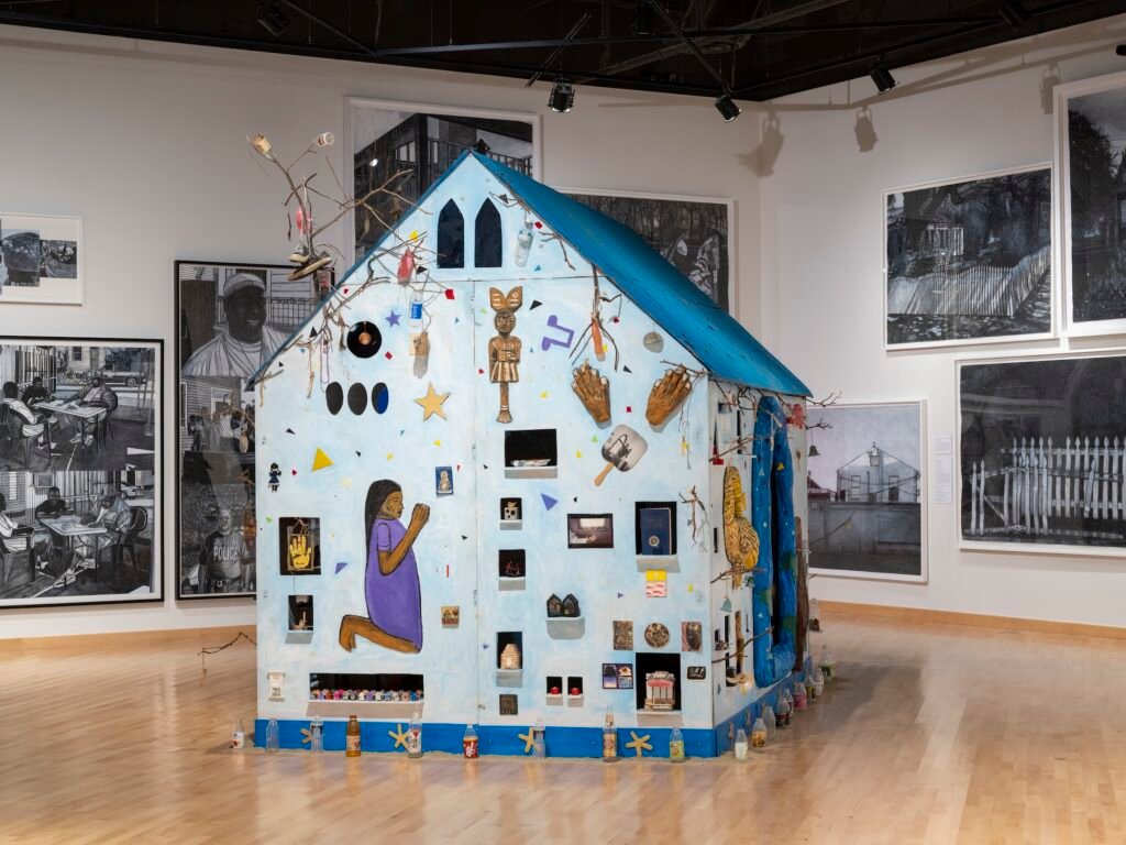Willie-Birch-house-installation-covered-in-painted-figures-and-found-objects-at-CAAMs-Stories-to-Tell