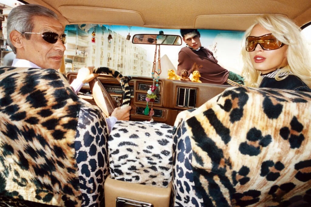 Casablanca-FW26-Carnet-de-Voyage-campaign-shot-by-Theo-Liu-four-people-inside-a-vintage-car-with-leopard-print-seat-covers-driving-through-daytime-Cairo