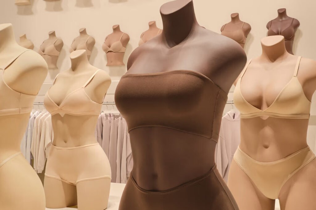SKIMS-shapewear-and-bras-displayed-on-mannequins-in-a-range-of-nude-and-brown-tones-inside-the-store