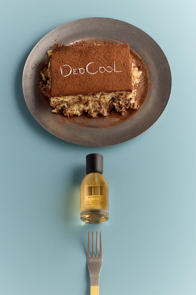 Tiramisu-with-DedCool-written-in-the-cocoa-dusting-above-a-Mocha-Magic-bottle-and-fork-on-blue