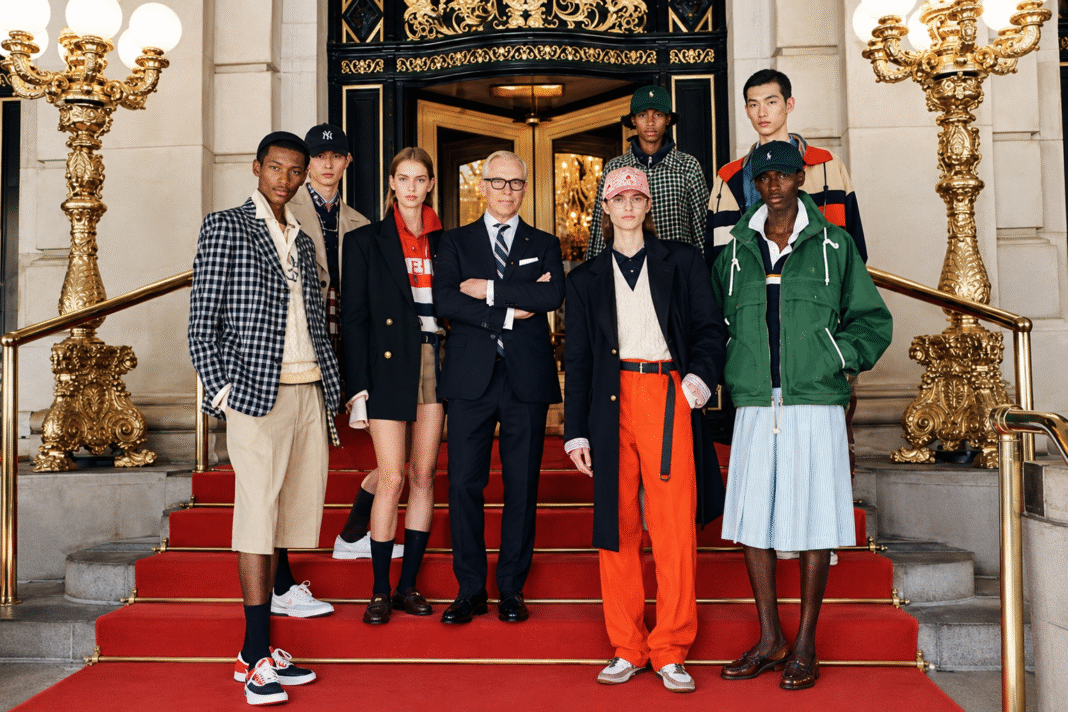 Tommy Hilfiger stands with eight models in prep separates on the red-carpeted steps of The Plaza Hotel