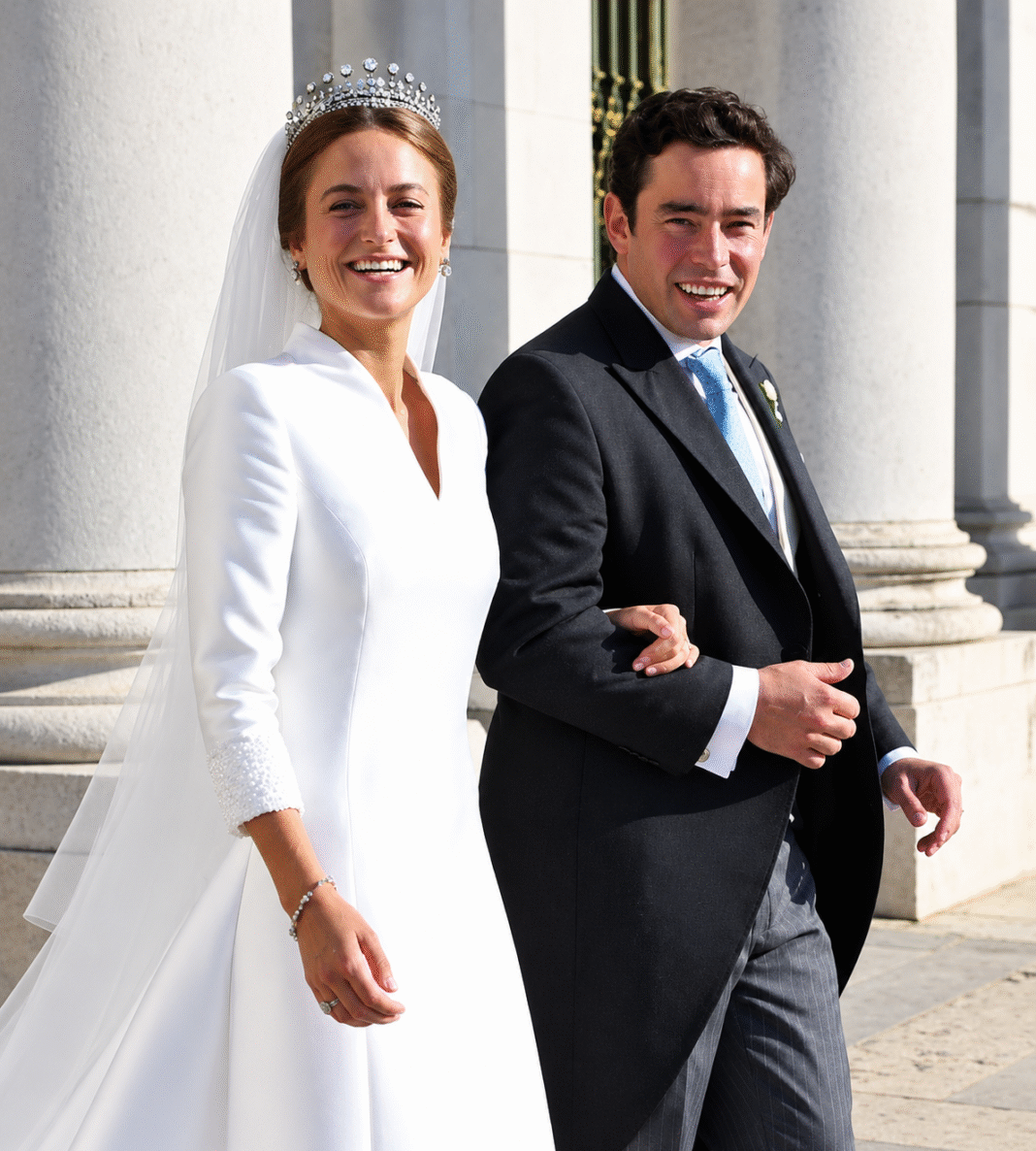 Duchess of Coimbra in diamond tiara and white bridal gown beside her groom in morning dress at Mafra